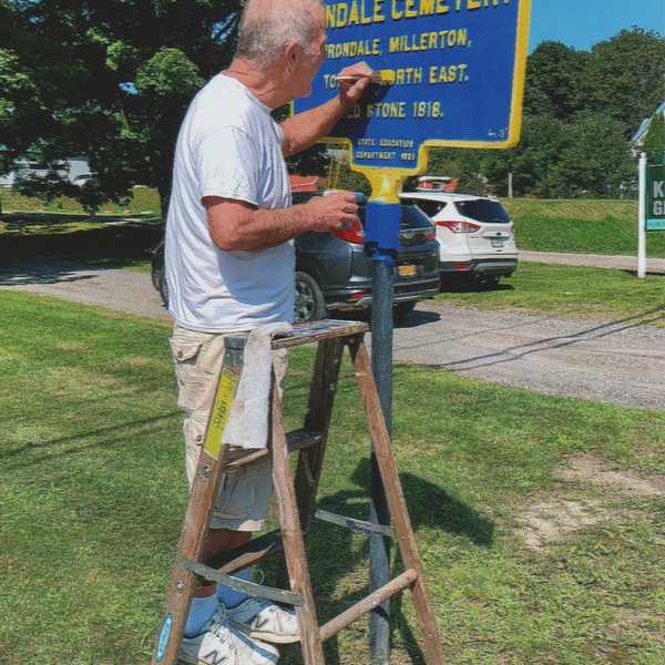 Speaking signs with local volunteer restorer