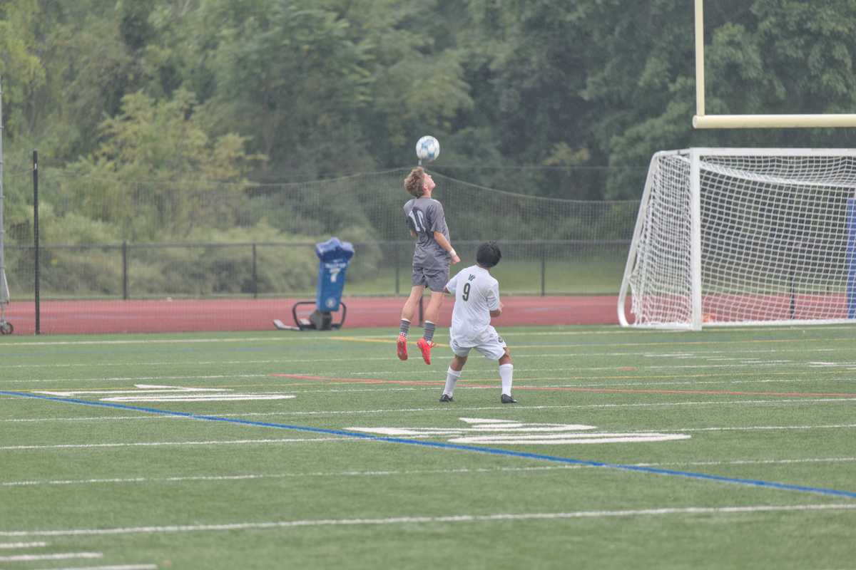 Soccer player heads ball